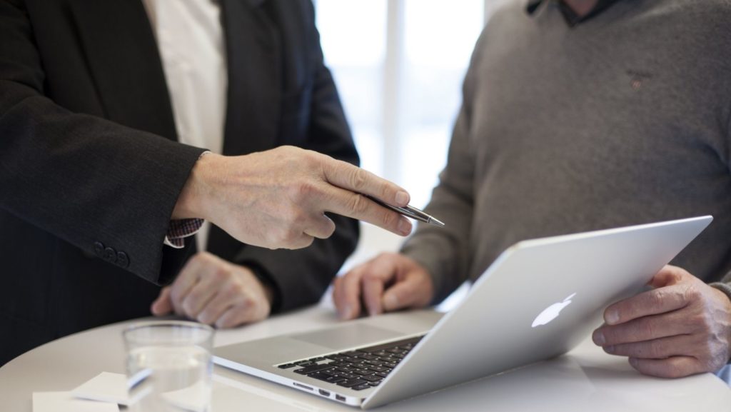 an seo consultant showing a startup owner his metrics
