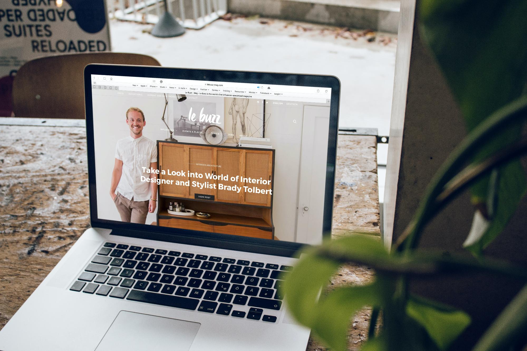 A photo of a laptop with a homepage to an interior designer