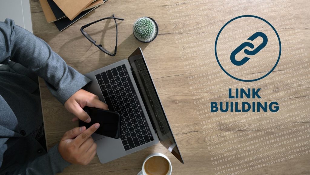 man sitting at his laptop with the words link building