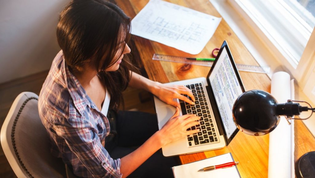 female blogger sitting at a desk